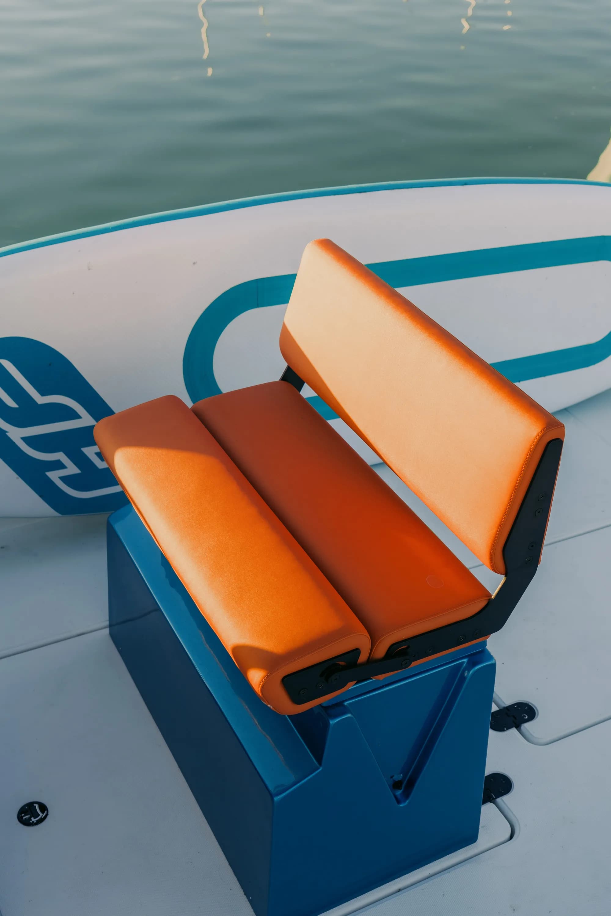 The open deck of the Wia 230 CC with orange bow cushions and a walk-around layout.