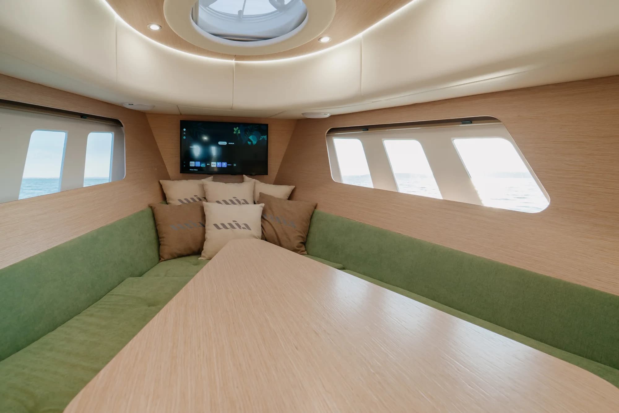 A cabin of the Wia 450 Cabrio finished in pale oak with soft natural light from the hull windows.