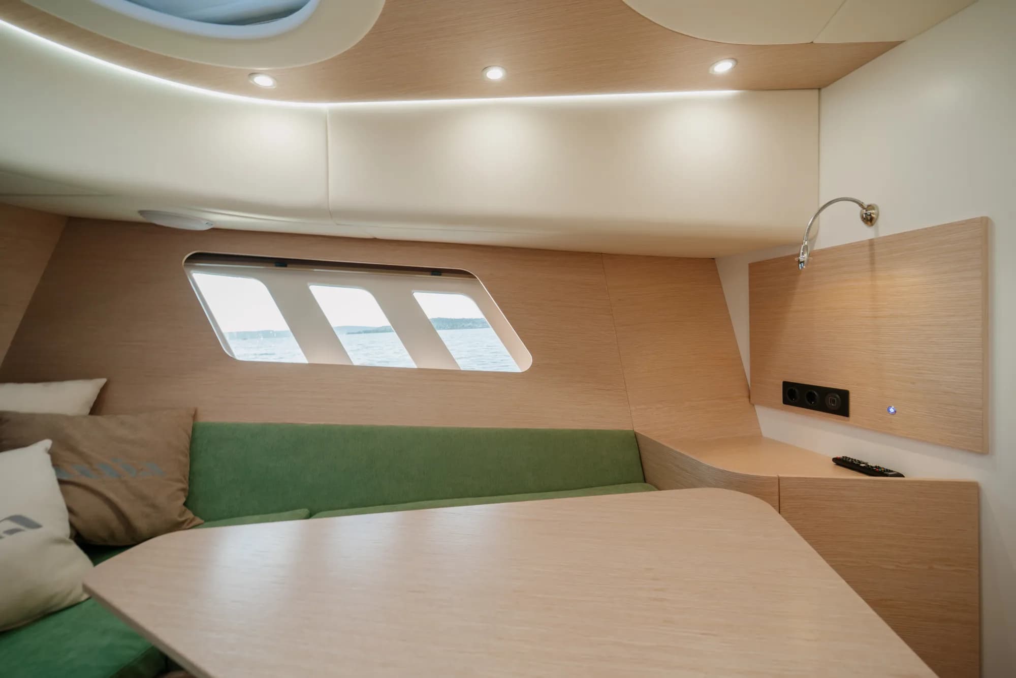The light-oak interior of the Wia 450 Cabrio with its green upholstery and soft lighting.