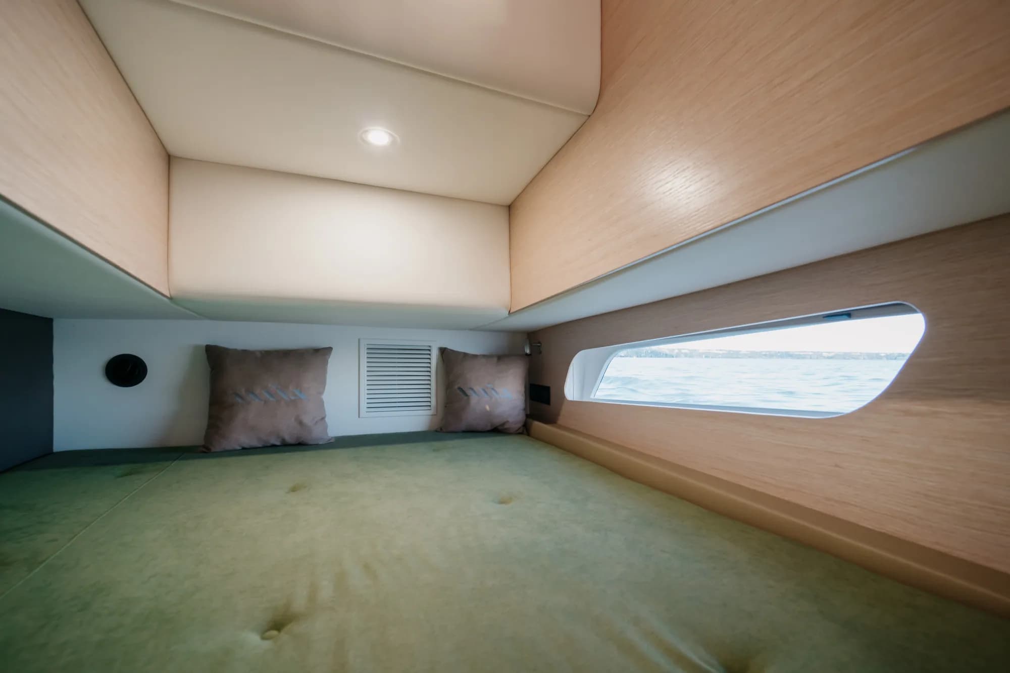 The light-oak interior of the Wia 450 Cabrio with its green upholstery and soft lighting.