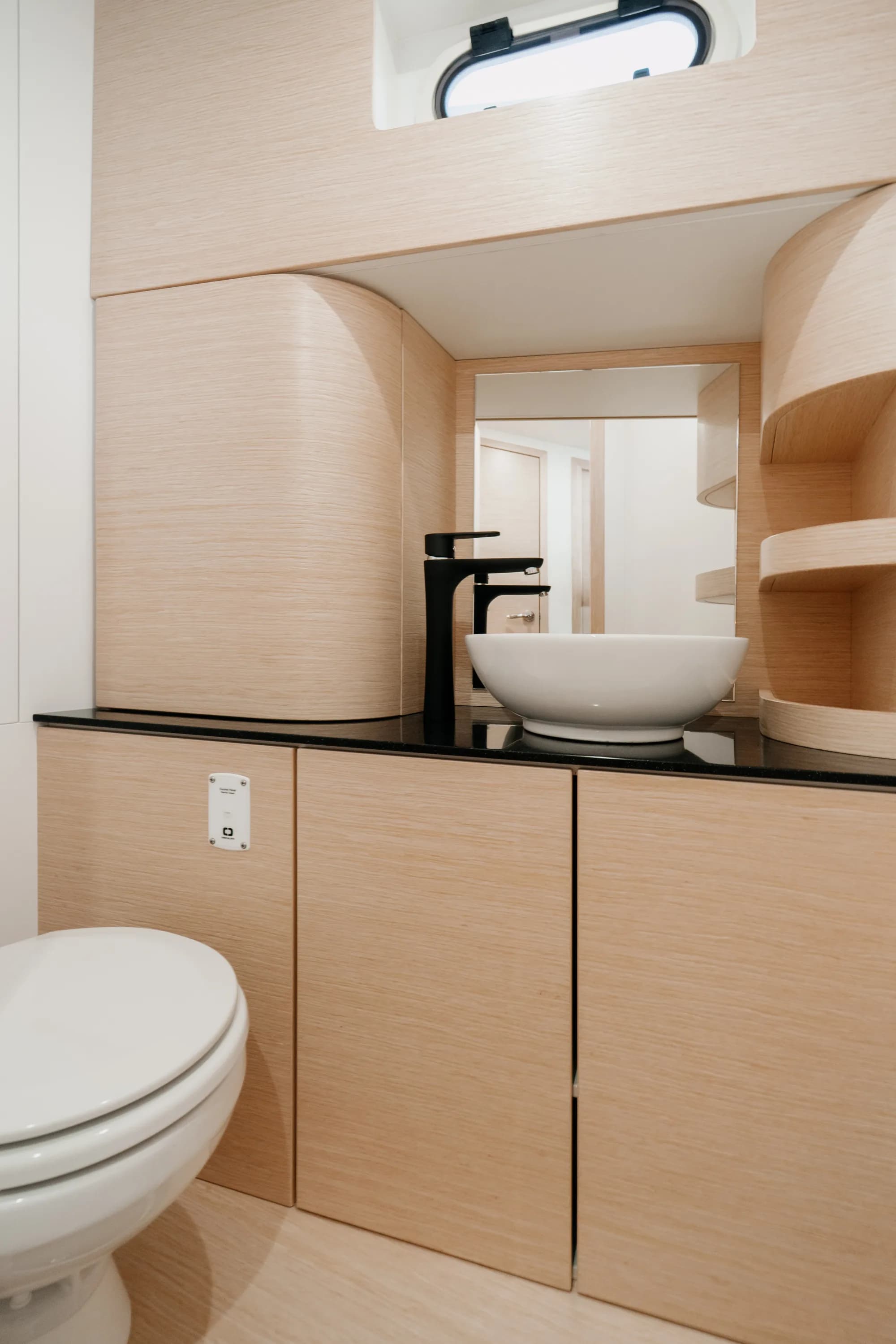 The light-oak interior of the Wia 450 Cabrio with its green upholstery and soft lighting.
