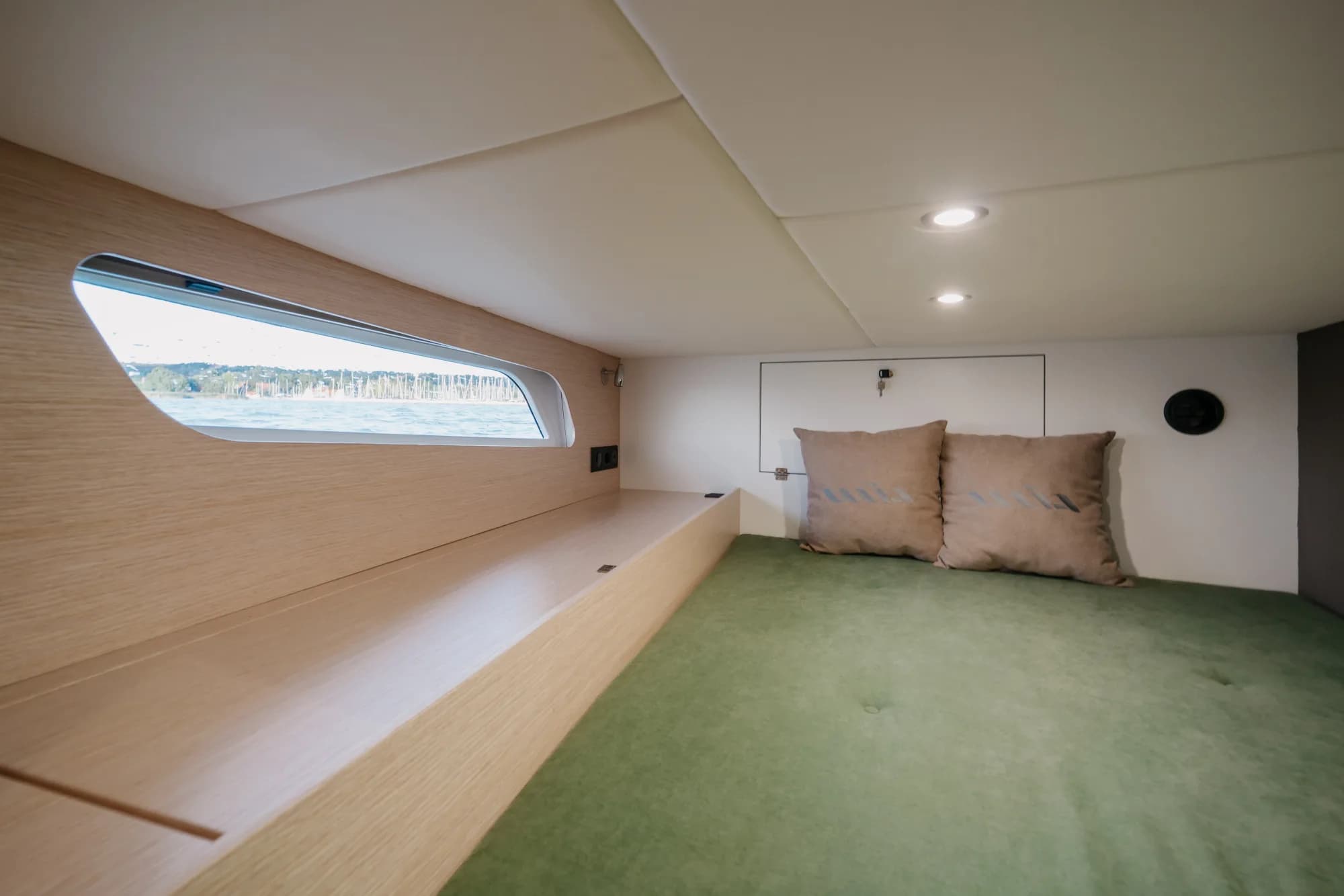 The light-oak interior of the Wia 450 Cabrio with its green upholstery and soft lighting.