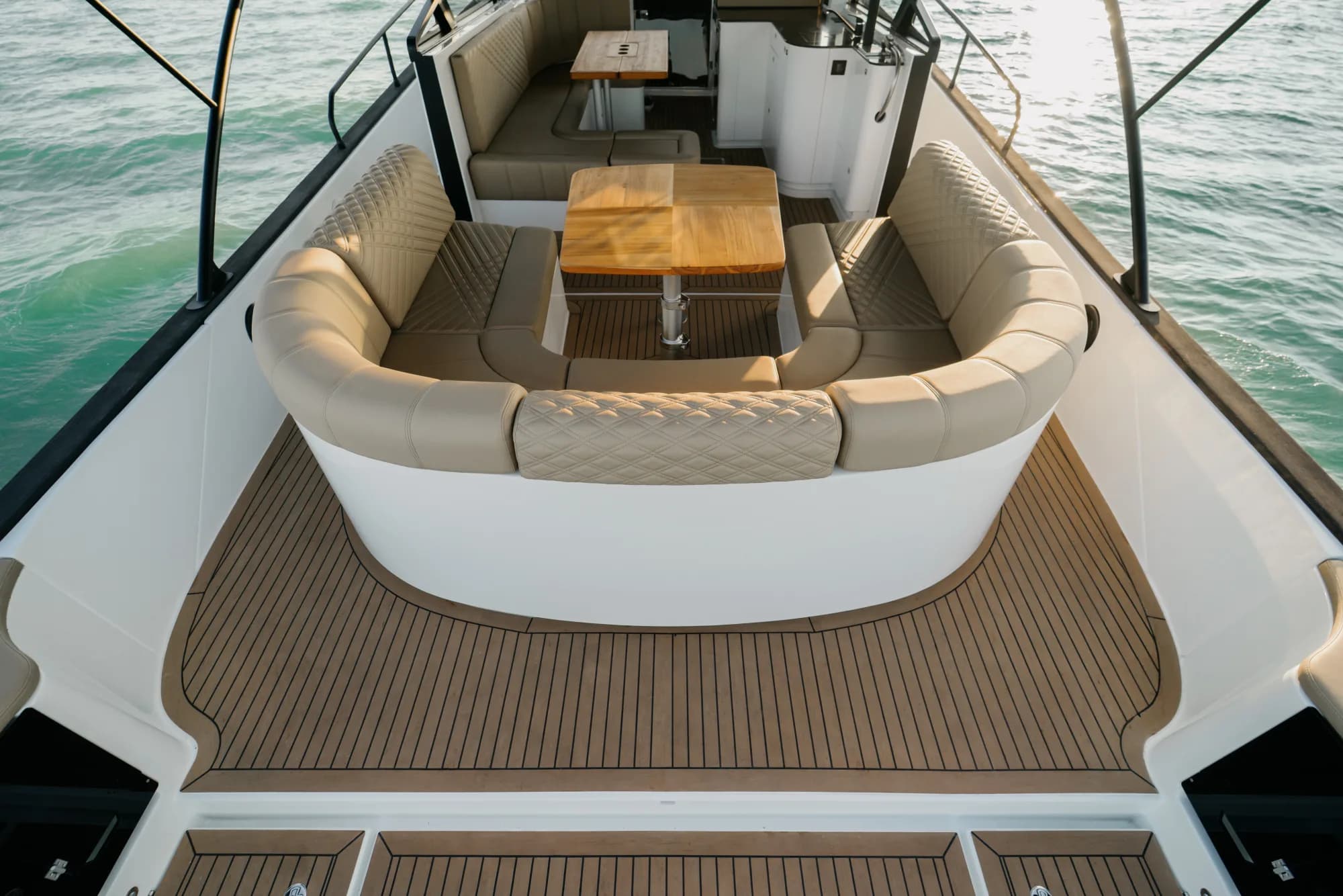The deck and cockpit of the Wia 450 Cabrio, cream seating and teak details under the black canvas top.