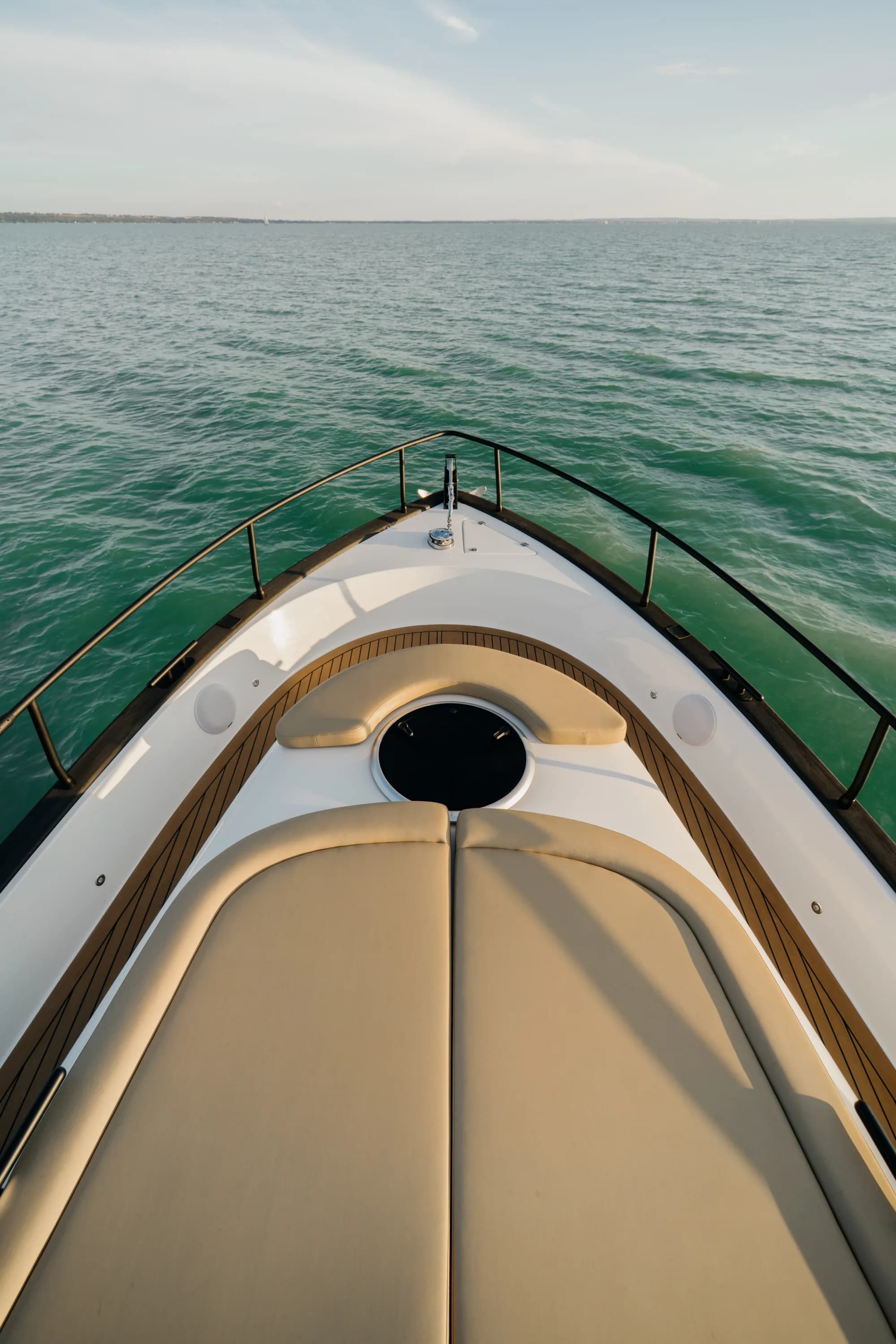 The deck and cockpit of the Wia 450 Cabrio, cream seating and teak details under the black canvas top.