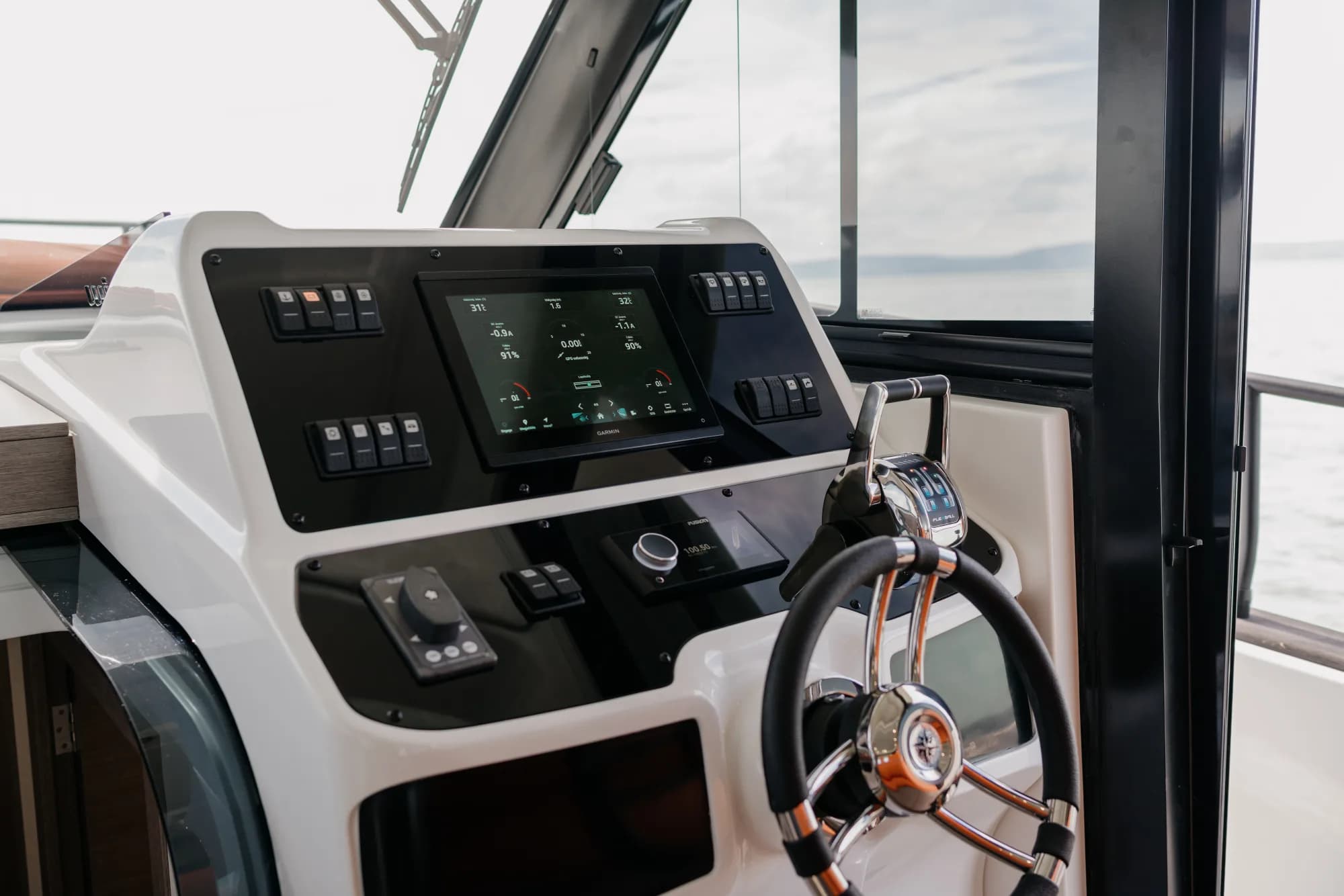 The teak-trimmed deck of the Wia 450 HardTop with orange sunpads and stainless rails.