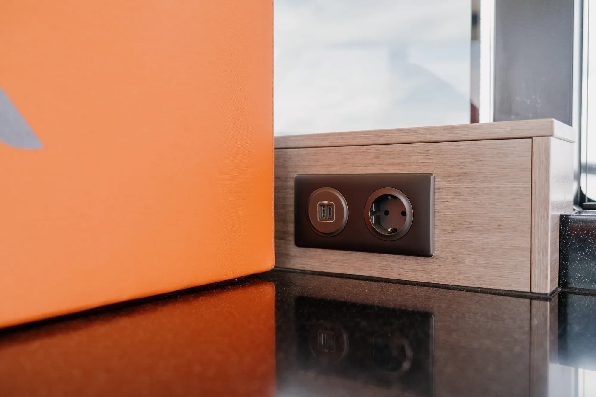 The teak-trimmed deck of the Wia 450 HardTop with orange sunpads and stainless rails.
