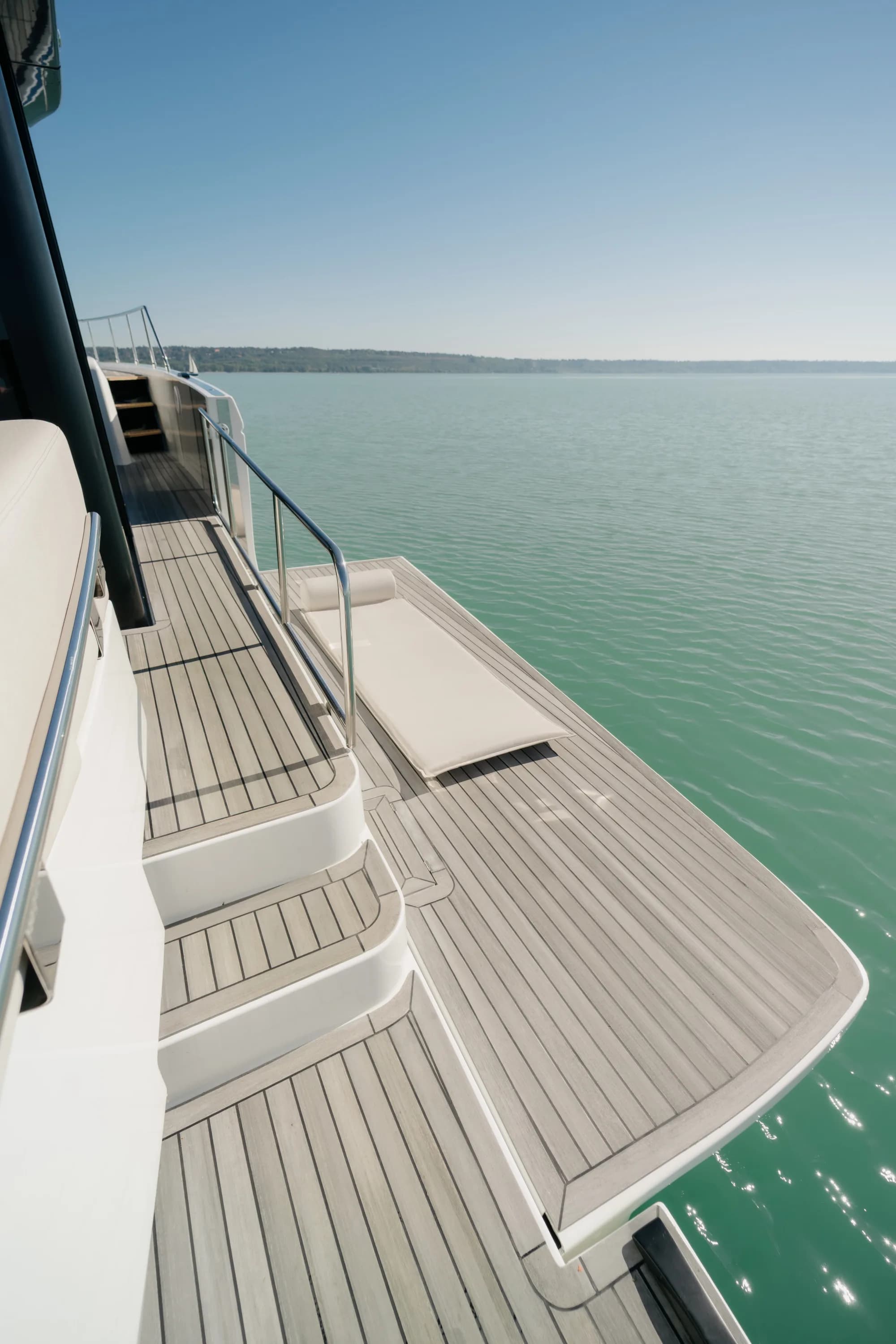 The white-hulled Wia 520 HardTop under way, its dark hardtop with roof solar panels over the enclosed saloon and teak decks.