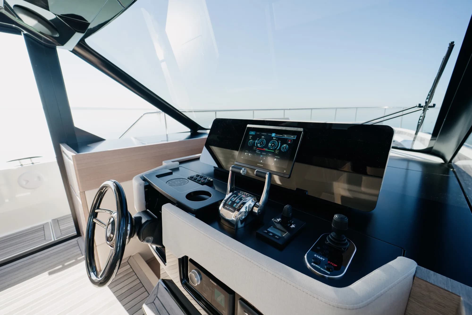 The teak deck of the Wia 520 HardTop with the open aft cockpit and cream seating.