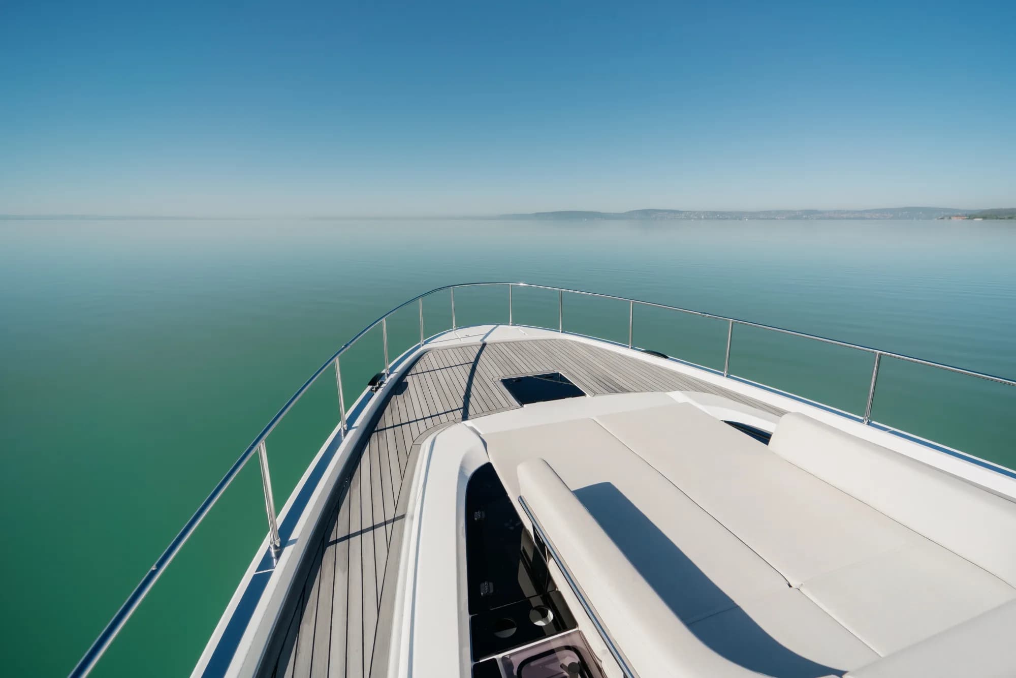 The teak deck of the Wia 520 HardTop with the open aft cockpit and cream seating.