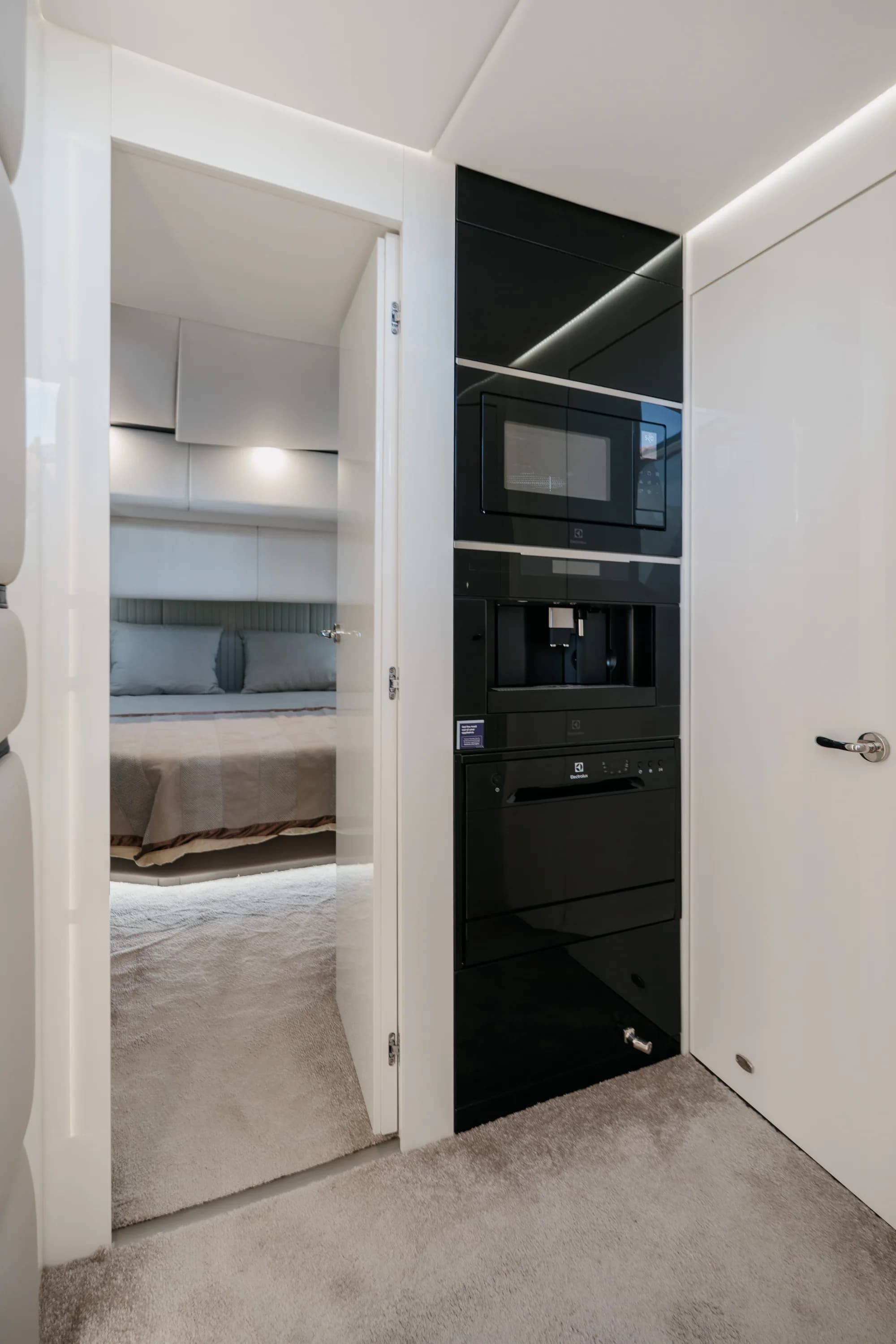 An interior of the Wia 520 Open finished in cream and pale oak, with soft natural light from the hull windows.
