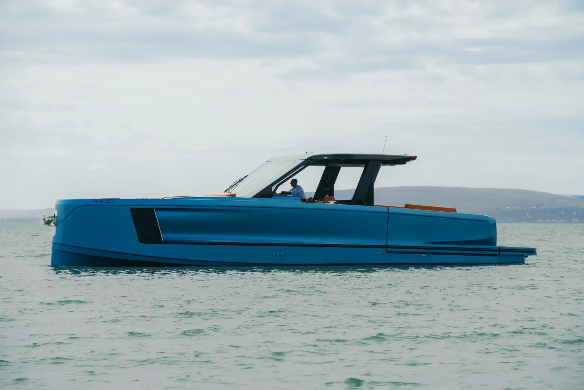 Die blau gerumpfte Wia 520 Open in schneller Fahrt, eine klare Kielspur hinter dem teakverzierten Spiegel.